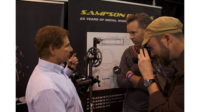 Eric Sampson explains his adjustable pedal to two bike fitters from the Boulder Center for Sports Medicine. Eric Sampson explains his adjustable pedal to two bike fitters from the Boulder Center for Sports Medicine.