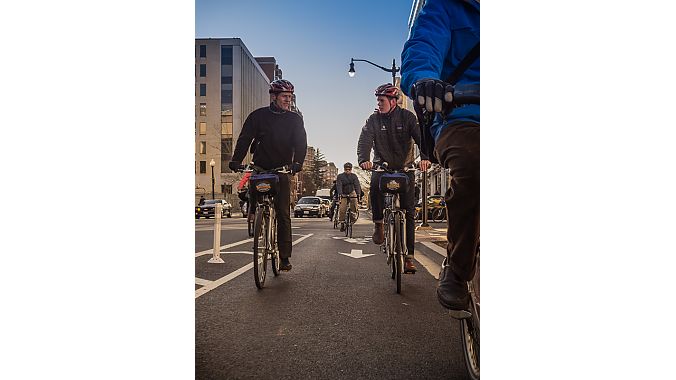 Hill Abell (left), owner of Bicycle Sport Shop in Austin, Texas, and Brandon Buth, advocacy manager for Trek Bicycle, chat while on a ride Monday as part of a tour hosted by Bikes Belong Foundation's Green Lane Project.