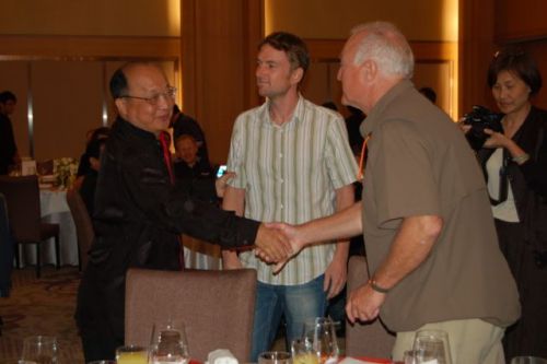 Mayor Jason Hu shaking hands with Eurobike's Erich Reiss and Eurobike show director Stefan Reisinger looks on.