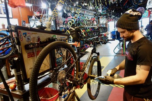 University Bikes' Michael Pope prepares to wipe down a service bike on Sunday. BRAIN Photo.
