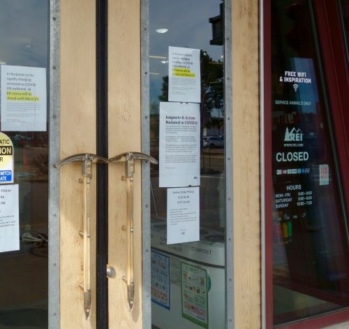 Signs on the door of the REI in Boulder, Colorado, Monday morning. 