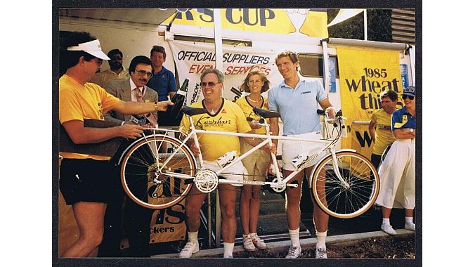 At the 1985 Beverly Hills Celebrity Bike Race, Cohen (center) presents a Kuwahara tandem to race winner Kiki Vandeweghe (far right) of the Los Angeles Lakers. This small tandem was later exchanged for a larger bike to fit the 6-foot-8 Vandeweghe.