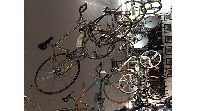 Samples from Hrach Gevrikyan’s 100-plus collection of vintage bikes adorn the ceiling at Velo Pasadena.