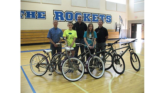  Grand prize bike winners receiving their Raleigh bicycles. From left to right: Scott Cowan (owner of Century Cycles), winner Emma Keane, Chris Speyer (COO of Accell North America), winner Bridget Murphy, and Sean Burkey (Midwest Rep for Raleigh Bicycles). 