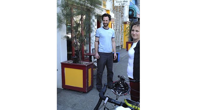 Good times in front of Mojo Bicycle Cafe with owner Remy Nelson and the coalition's Leah Shahum