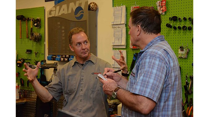 Smyrna Bikes co-owner Brown Loper (l) shares some fishing tales with BRAIN's Matt Wiebe.