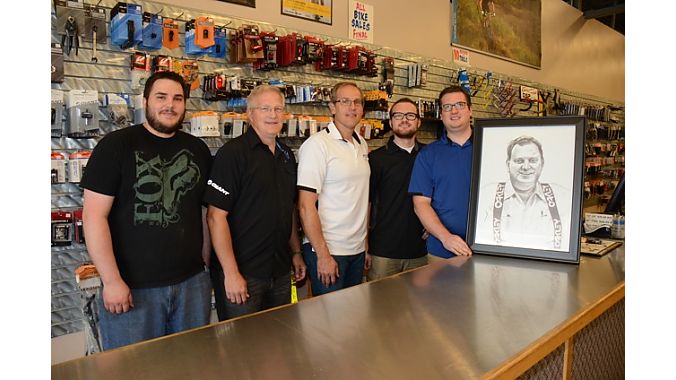 Three generations of the Taylor family, with founder Ron's portrait.