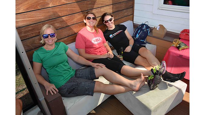 A few of the Ladies of Dealer Tour take advantage of the front patio at Division 1. BRAIN’s Val Vanderpool (left) and Megan Tompkins flank Bell Helmets’ Kristin Michal.