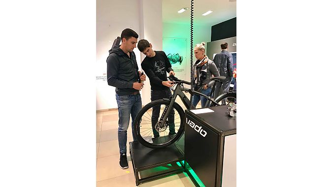 Dominik Geyer (middle), Specialized’s Turbo product manager, talks battery life and other details with customers in the new pop-up store. 