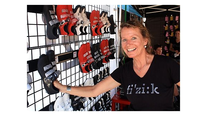 Fizik's Suzette Ayotte demonstrates the company's velcro shoe display system. Ayotte kept busy Monday helping sell 2012 model year shoes to retailers. 
