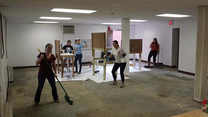 Volunteers build six workbenches that will be available for use in the community shop.