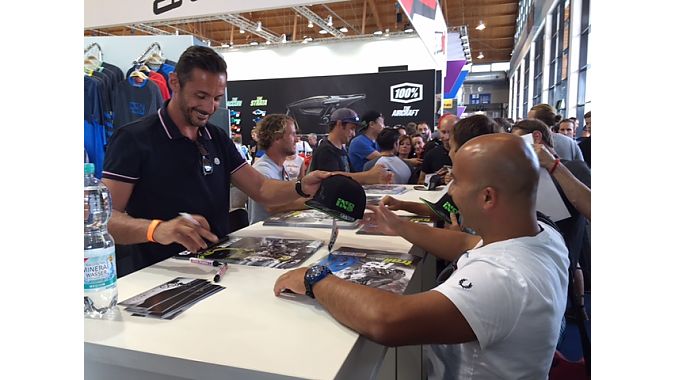 Fans line up for autographs from Cedric Gracia, Richie Schley and Darren Berrecloth at the iXS booth.