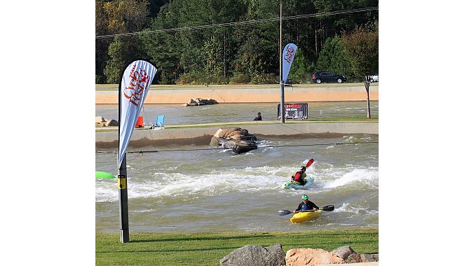 Kayakers paddle the manmade rapids at CycloFest host venue the U.S. National Whitewater Center.