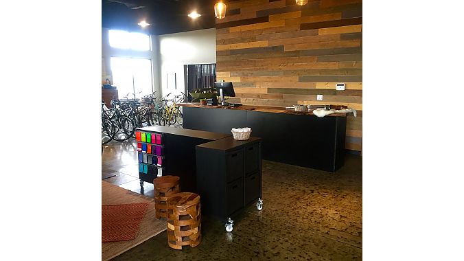 Leaning H owner Heather Henderson included a custom maple cash wrap and reclaimed barn wood in her build-out.