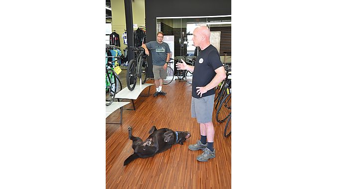 Shop dog Grizzly tried to steal the spotlight as Outspokin’ Bicycles’ Curran told the BRAIN Dealer Tour crowd about his business.