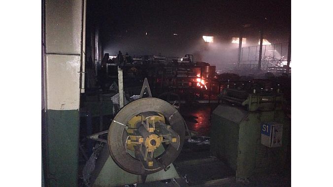 Fire burns inside the manufacturing facility.