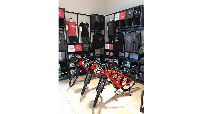 A selection of apparel and accessories, including ‘Ride Dusseldorf’ T-shirts and sweatshirts, is for sale at the store.