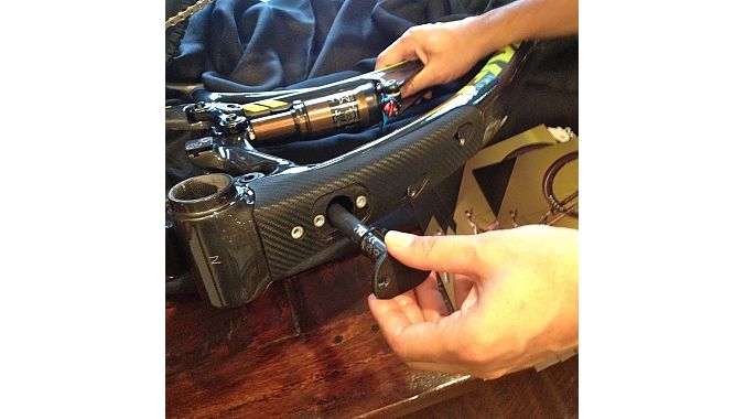 Pivot's Chris Cocalis demonstrates how to stow the Di2 battery inside the Mach 4 via the frame's downtube port. 