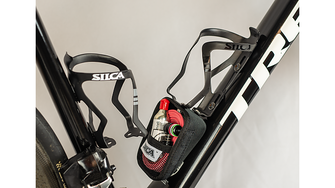 The Sicuro Capsule is a magnetically closing storage cage that bolts to the accessory ports on Sicuro carbon cages.