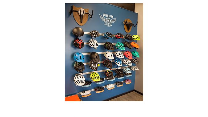 The shop's helmet wall incorporates bike art.