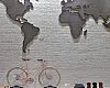 A 1930s world map sculpture hangs over a Shinola city bike