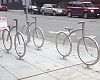 Stylish bike racks outside retailer Velo and apartment high rise Via6