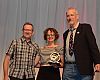 Flanked by the Mann Group’s Dan Mann (left) and BPSA’s Ray Keener, Gladys Bikes owner Leah Benson of Portland, Oregon, accepts the Interbike Award for Best Women’s/Female-Friendly Shop during a gala the closing night of the show. Thirty-six awards were handed out at the inaugural honors.