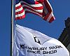 The flagpole from the former post office Newbury Park Bicycle Shop moved into last spring is grandfathered into the building's lease, allowing the shop to fly its banner alongside the Stars and Stripes.