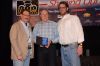 Steve Meineke (center) accepts a BRAINy award.